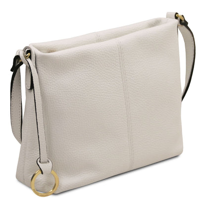 Soft white pebbled leather shoulder bag with adjustable strap and subtle gold ring hardware accents.