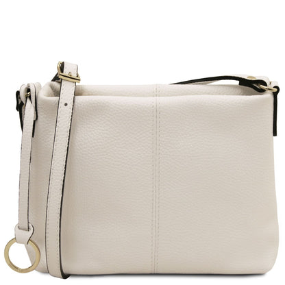 Cream-colored soft leather shoulder bag with adjustable strap and gold-tone ring detail on the side.