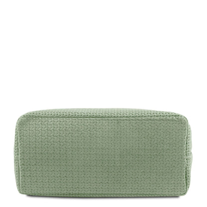 Bottom view of a mint green woven leather handbag
