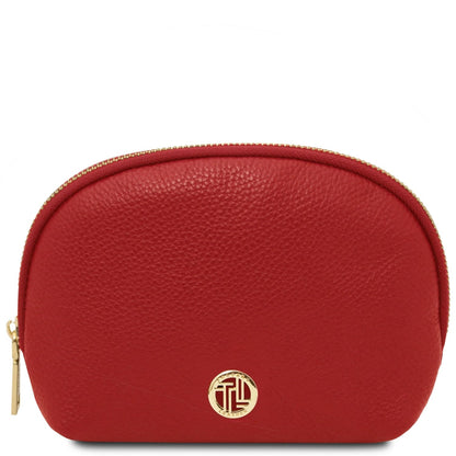 Red pebbled leather toiletry case with curved gold zipper and round gold logo on the front.