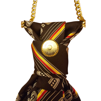 Close-up of brown patterned 4-in-1 Jeweled Tie knot with a gold coin accent and chain