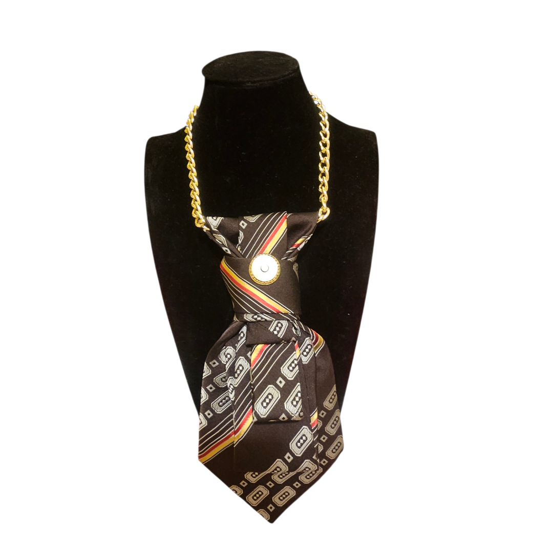 Vintage brown 4-in-1 jeweled tie displayed on a black bust with a gold chain necklace.