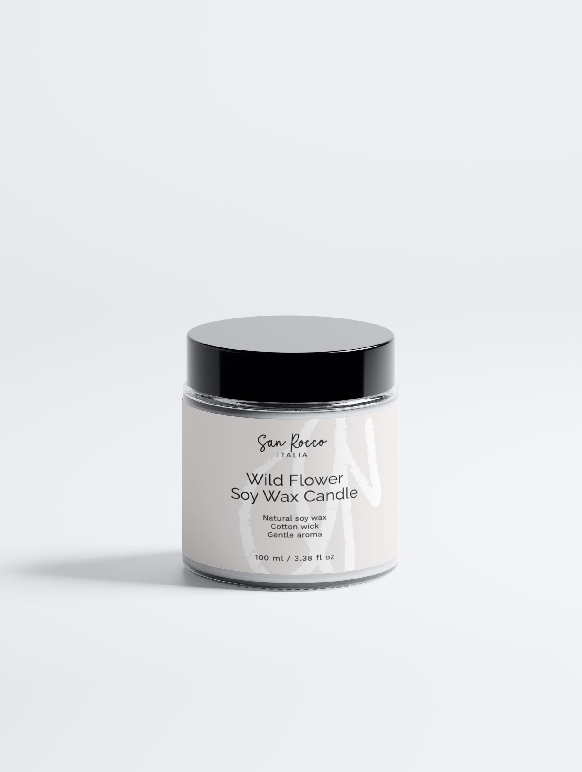 White candle jar with black lid on a white background