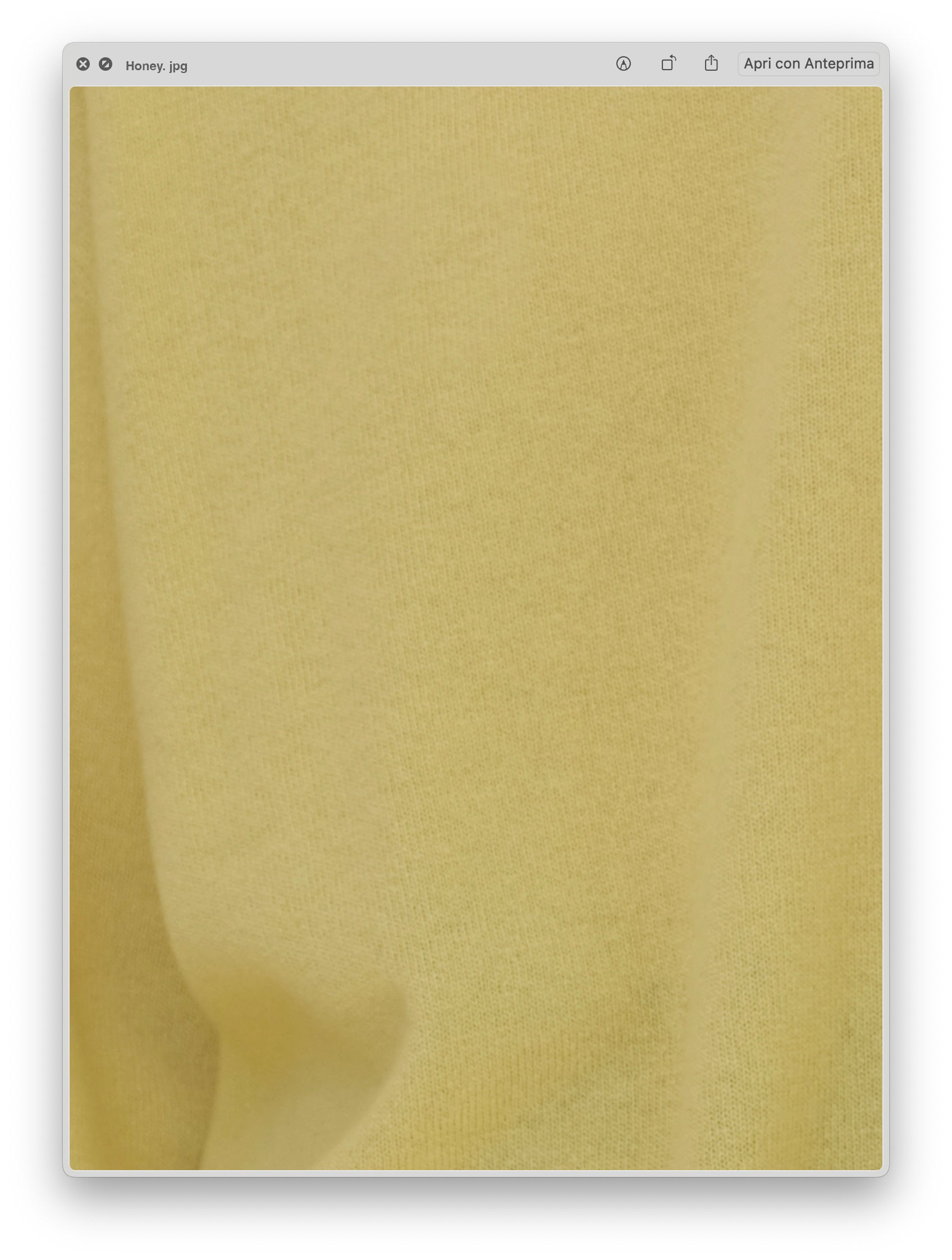 Close-up of pale yellow knit fabric texture