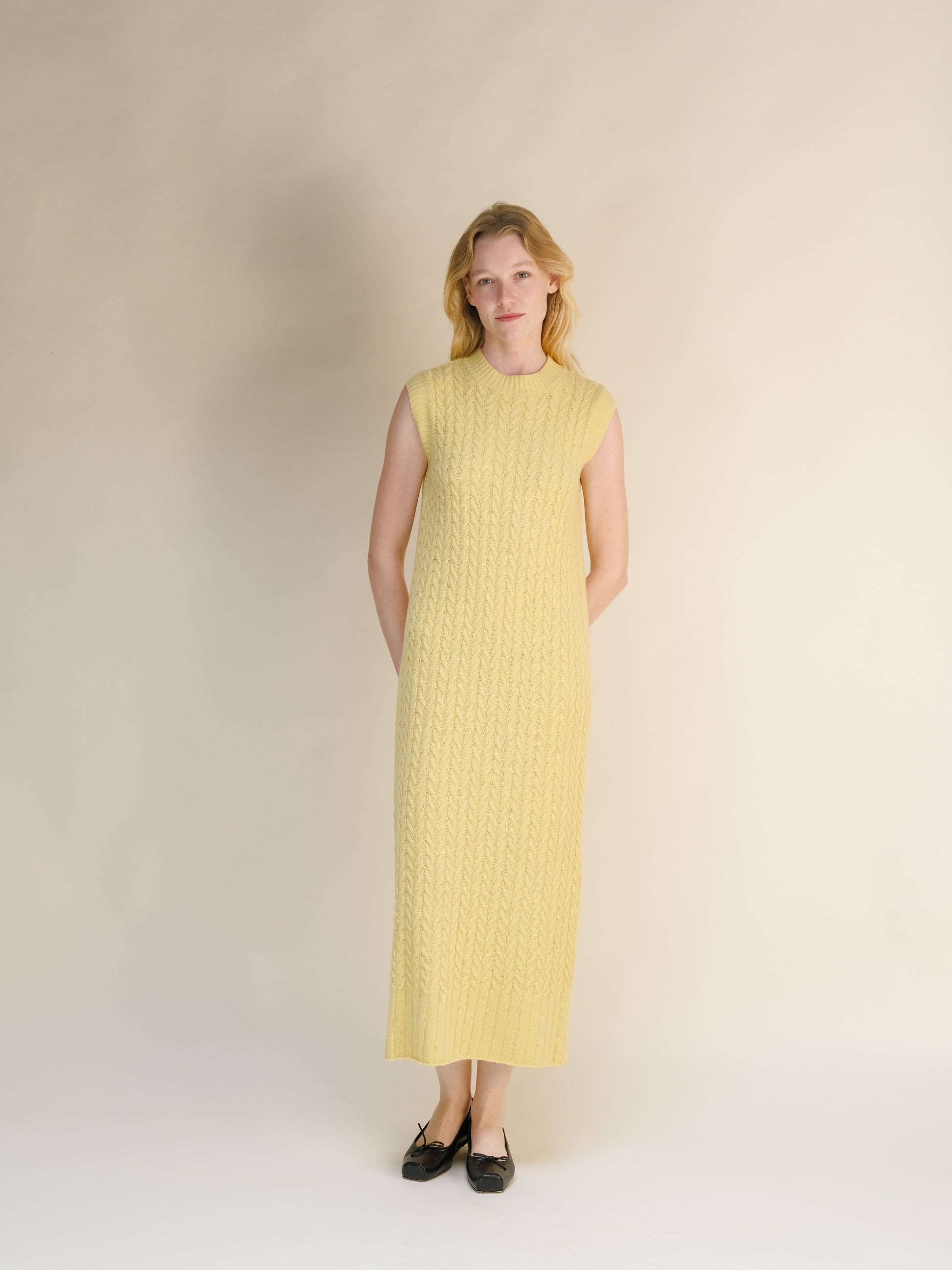 Yellow Wool & Cashmere Mix Sleeveless Cable Knit Dress with a textured cable pattern and a high neckline in a long midi length.