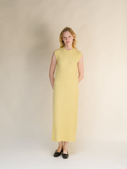 Yellow Wool & Cashmere Mix Sleeveless Cable Knit Dress with a textured cable pattern and a high neckline in a long midi length.
