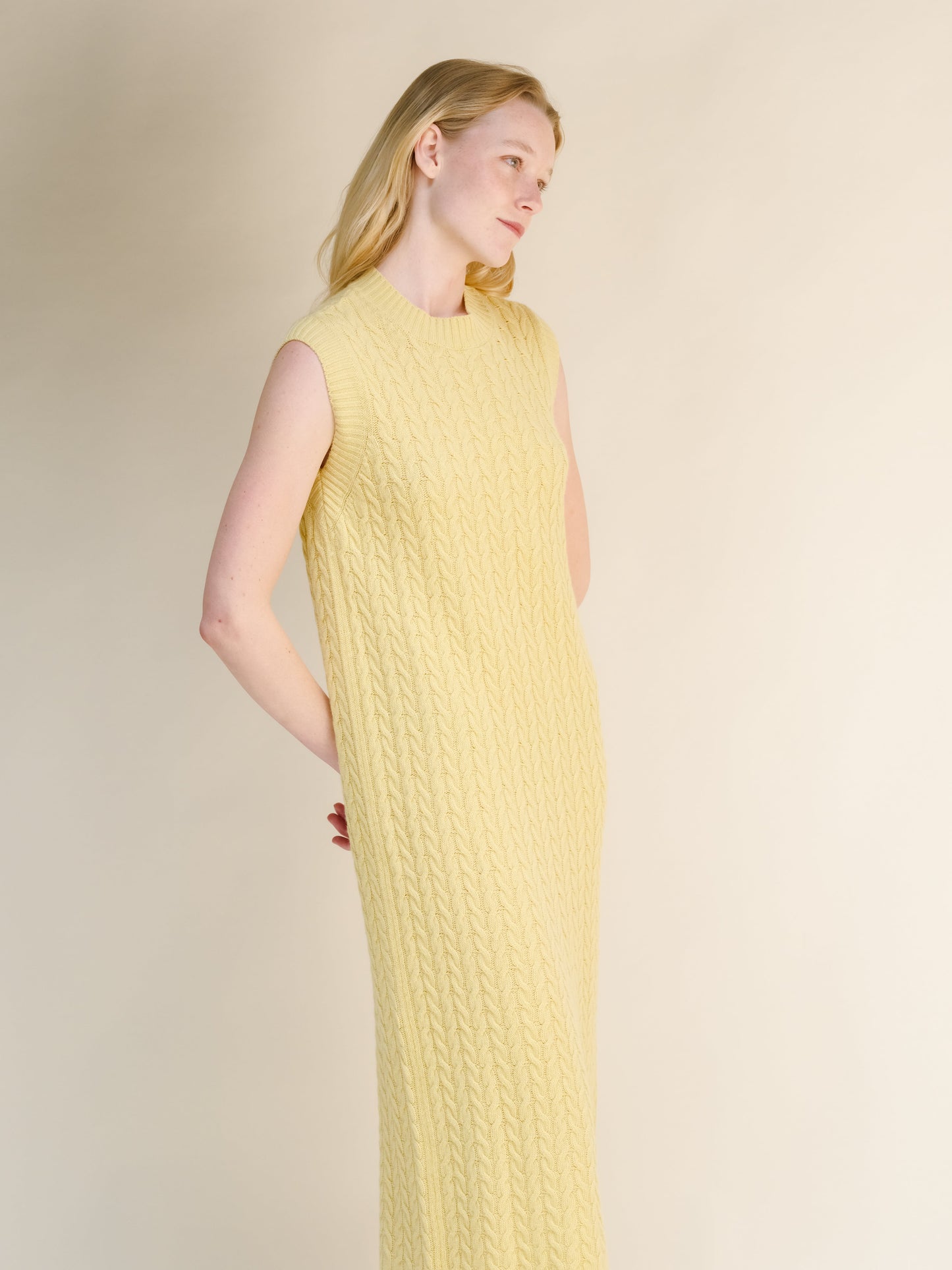 Wool & Cashmere Mix Sleeveless Cable Knit Dress in pale yellow featuring a detailed cable knit texture and a sleeveless silhouette.