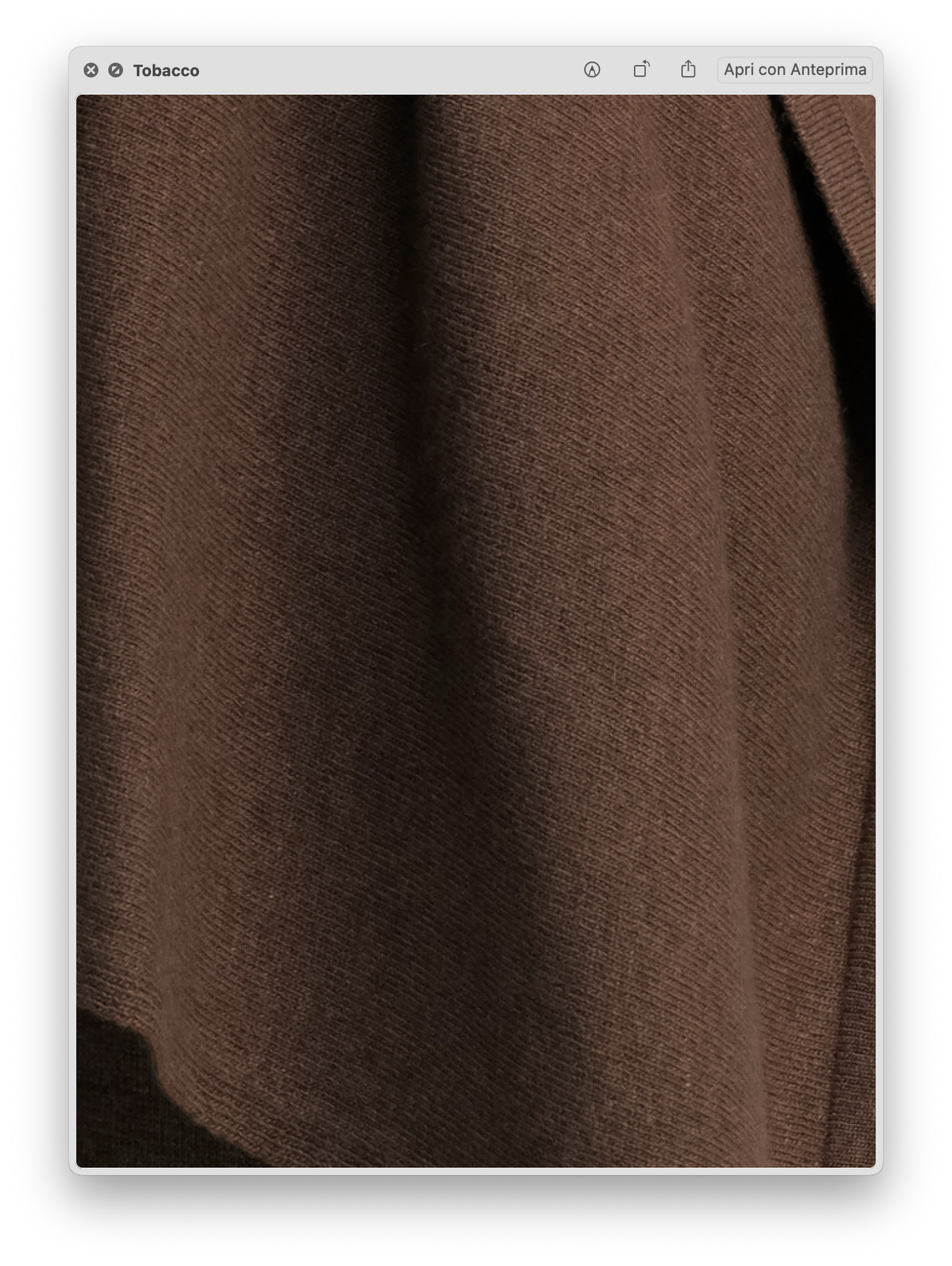 Close-up of the soft, smooth brown knit fabric texture of the Wool & Cashmere Mix Solid Maxi Turtleneck Sweater.